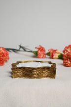 Decorative gold candles on a light gray background with pink flowers.